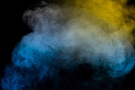 Blue and yellow steam on a black background.の写真素材