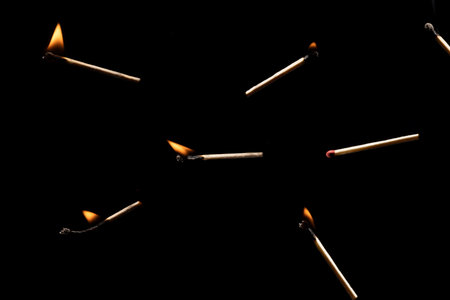 Lit and falling match on a black background.の写真素材