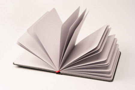Open notebook with blank pages isolated on a white background. Top view.の写真素材