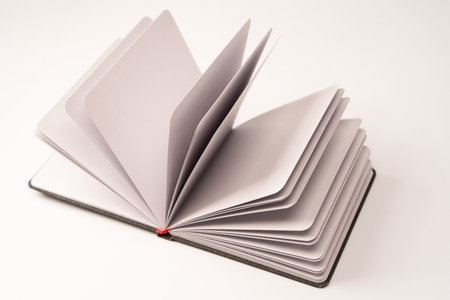 Open notebook with blank pages isolated on a white background. Top view.の写真素材