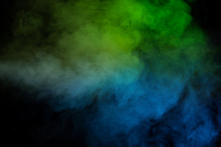 Blue and yellow steam on a black background.の写真素材