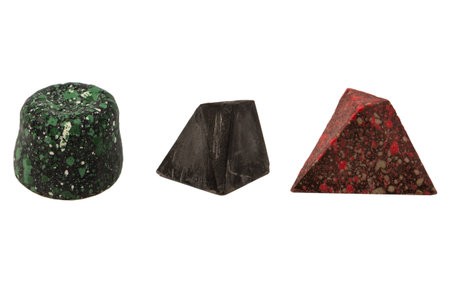 Chocolate candies in the form of precious stones, with marble texture, isolated on a white background.の写真素材