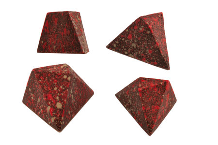 Chocolate candies in the form of precious stones, with marble texture, isolated on a white background.の写真素材