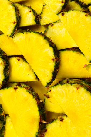 Pineapple juicy yellow slices background. Top view.の写真素材