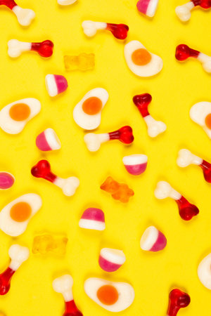 Assorted jelly sweets on yellow background. Patternの写真素材