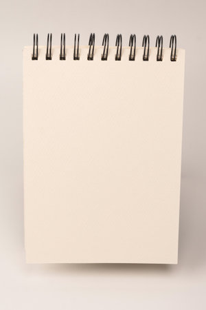 White empty spiral notebook mockup, copy space. Isolated on a white background. Top view.の写真素材