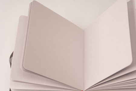 Open notebook with blank pages isolated on a white background. Top view.の写真素材