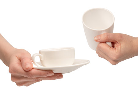 Hand holding coffee cup and saucer isolated on a white background.の写真素材
