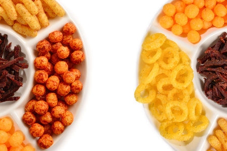 Mix of snacks on a white plate isolated on white.の写真素材