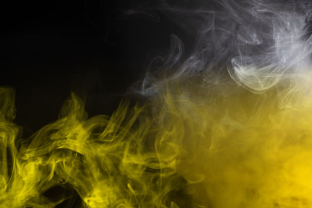 Yellow steam on a black background. Copy space.の写真素材