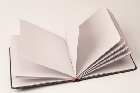 Open notebook with blank pages isolated on a white background. Top view.の写真素材