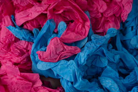 Pink and blue latex sterile medical gloves as a background.