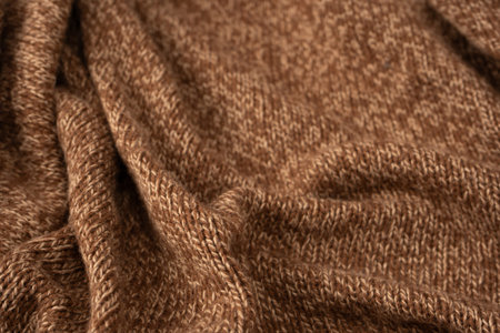 Soft brown merino wool sweater texture as a background. Top view.