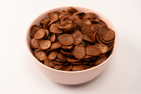 Chocolate cereal in a bowl isolated on a white background.