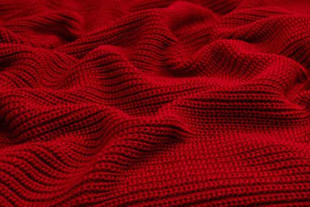 Red sweater texture as a background. Top view