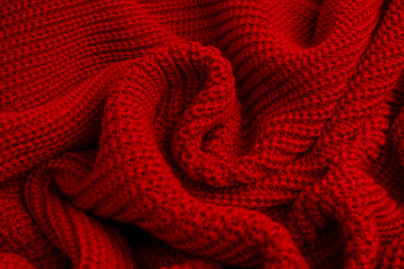 Red sweater texture as a background. Top viewの写真素材