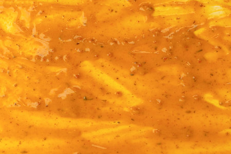 Yellow sauce splashes as a background. Top view.の写真素材