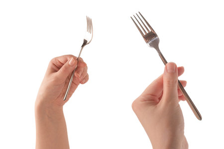 Fork in woman hand isolated on white background.の写真素材