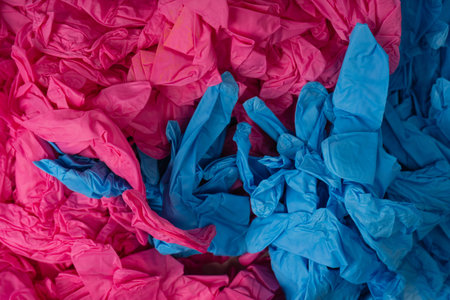 Pink and blue latex sterile medical gloves as a background.