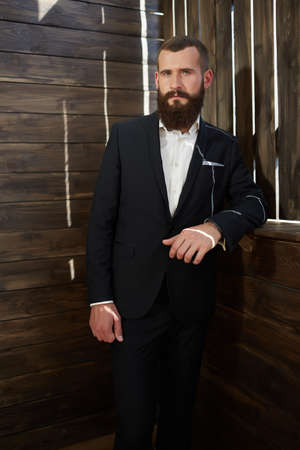 a young man in a suit with a beardの写真素材