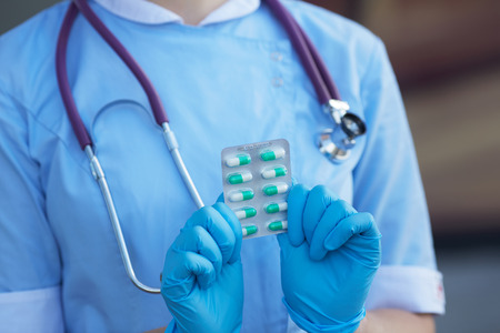 female doctor holding medicine capsulesの写真素材