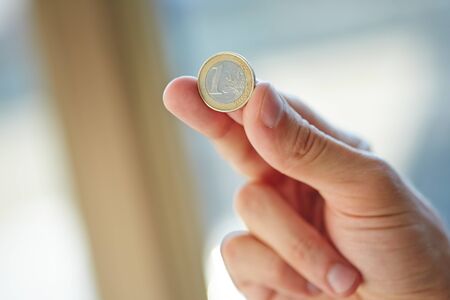 hand with euro coinの写真素材