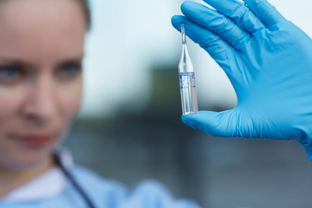 female doctor holding a vialの写真素材