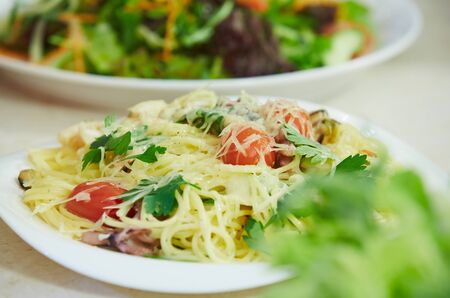 Spaghetti with cherry tomatoes and parsleyの写真素材