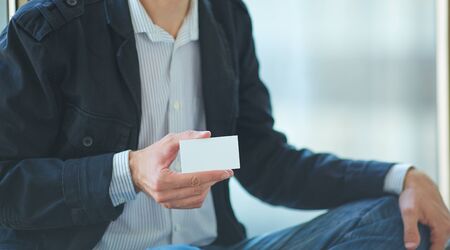 Man's hand showing business cardの写真素材