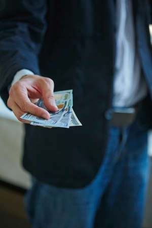Businessman holding money in his handsの写真素材