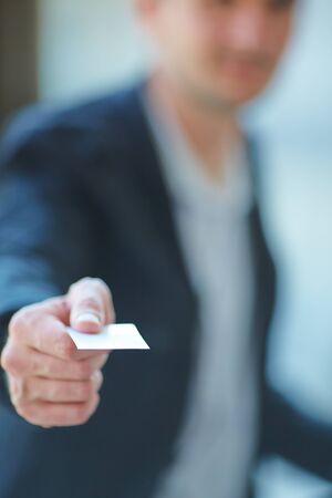 Man's hand showing business cardの写真素材
