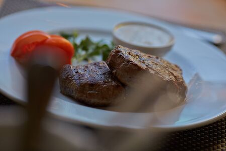 steak with sauce and vegetablesの写真素材