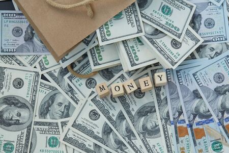 Wooden blocks - the inscription money. a lot of money out of a paper bag