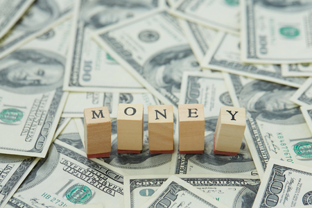 much money. Wooden blocks - the inscription moneyの写真素材