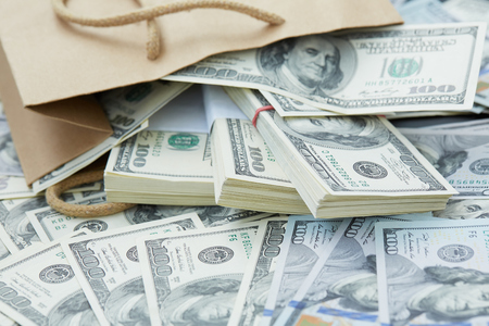 a lot of money out of a paper bagの写真素材