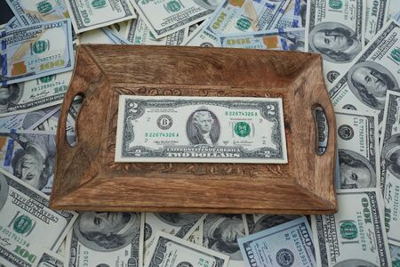 money on a wooden tray, two USDの写真素材