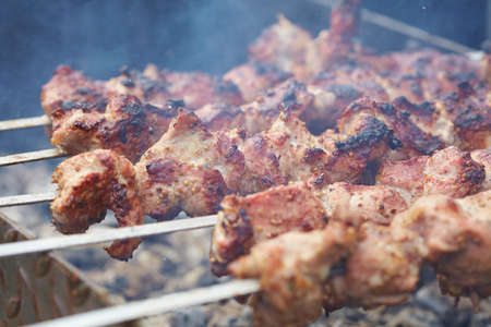 skewers frying on skewersの写真素材