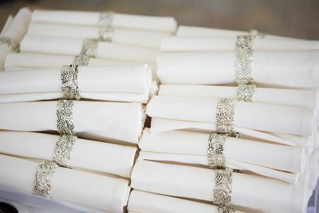 many curled napkins with rings in a restaurantの写真素材