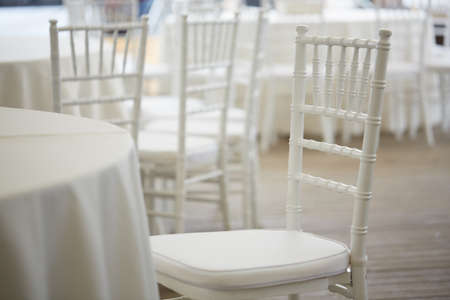 white tables and white chairs in the restaurant