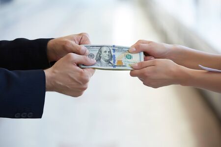 business woman and a businessman hold moneyの写真素材