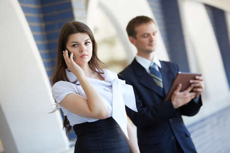 business woman with a telephone and a businessman with a tabletの写真素材