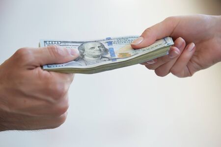 business woman and a businessman hold moneyの写真素材