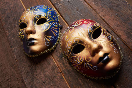 Venetian masks on a wooden tableの写真素材