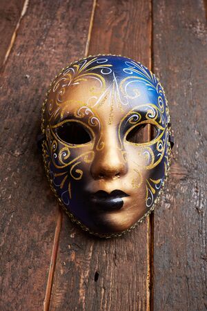 Venetian mask on a wooden tableの写真素材