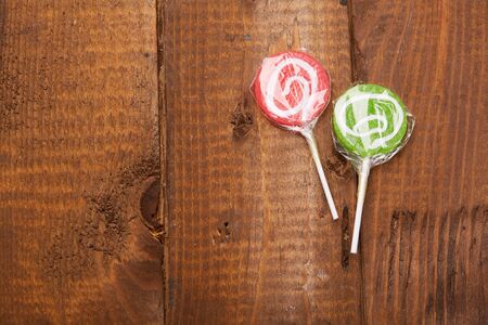candy on a stick on a wood backgroundの写真素材