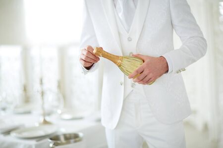 man opens champagne
