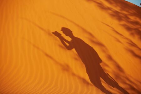 shadow of a man on the sand in Vietnamの写真素材