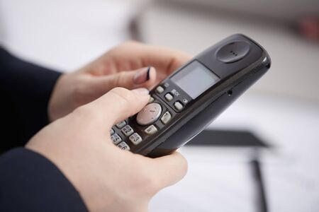 Radio phone in female handsの写真素材