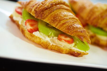 croissant with strawberry kiwi fruitの写真素材
