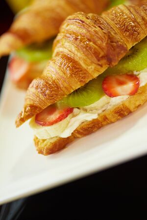 croissant with strawberry kiwi fruitの写真素材